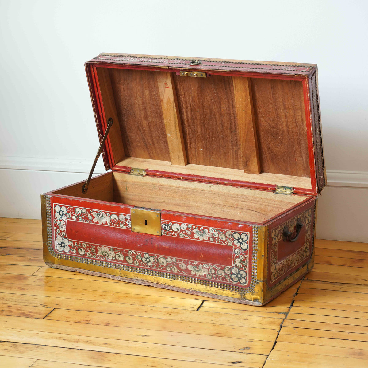 China trade red leather and brass bound camphor wood trunk, c. 1830