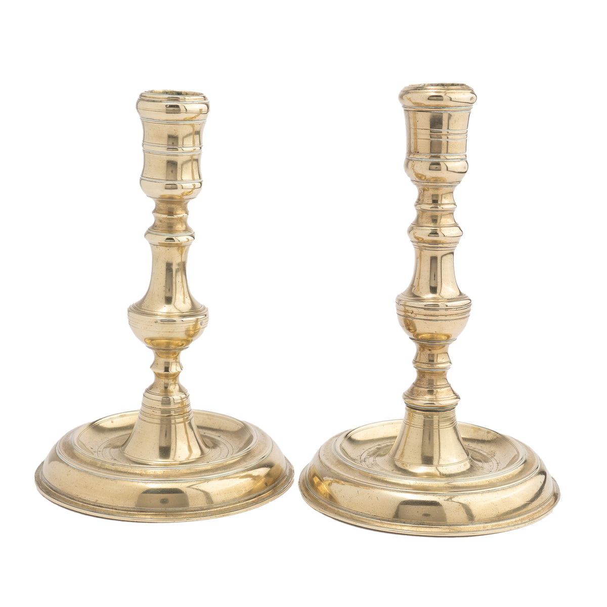 Assembled pair of French Louis XV cast brass chamber candlesticks, 1710-20