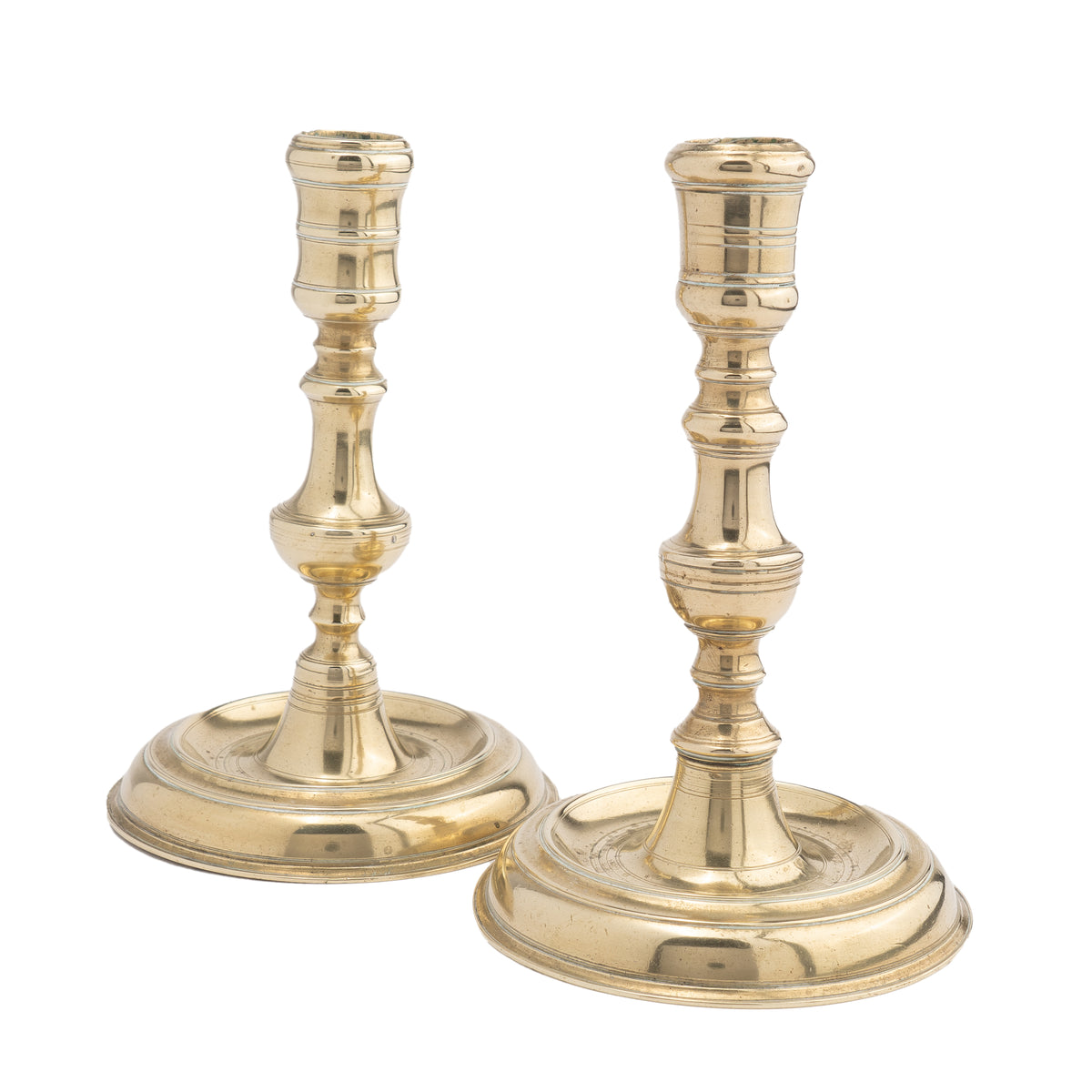 Assembled pair of French Louis XV cast brass chamber candlesticks, 1710-20