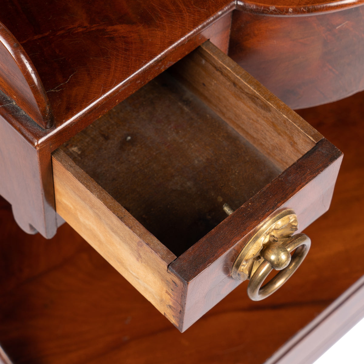American mahogany demilune dressing stand on brass castors, 1830s
